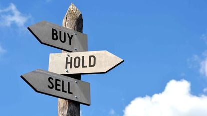 Signpost with Buy, Hold and Sell signs