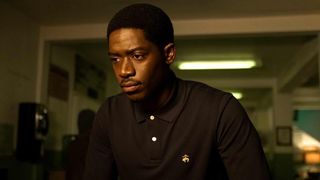 Damson Idris as Franklin in a black shirt staring off in Snowfall season 6