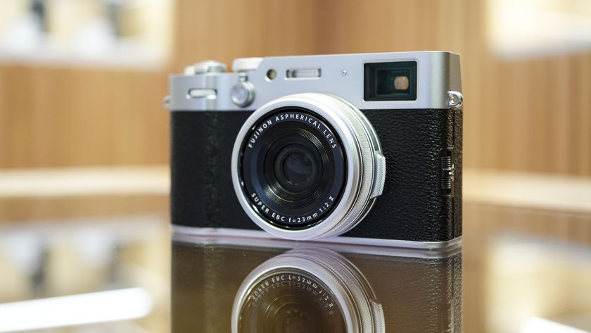 Front of the Fujifilm X100VI reflected in glass table