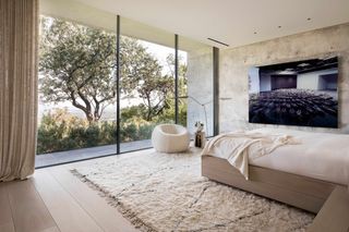 Bedroom with nature views at Austin house by Studio DuBois and Elizabeth Stanley design.