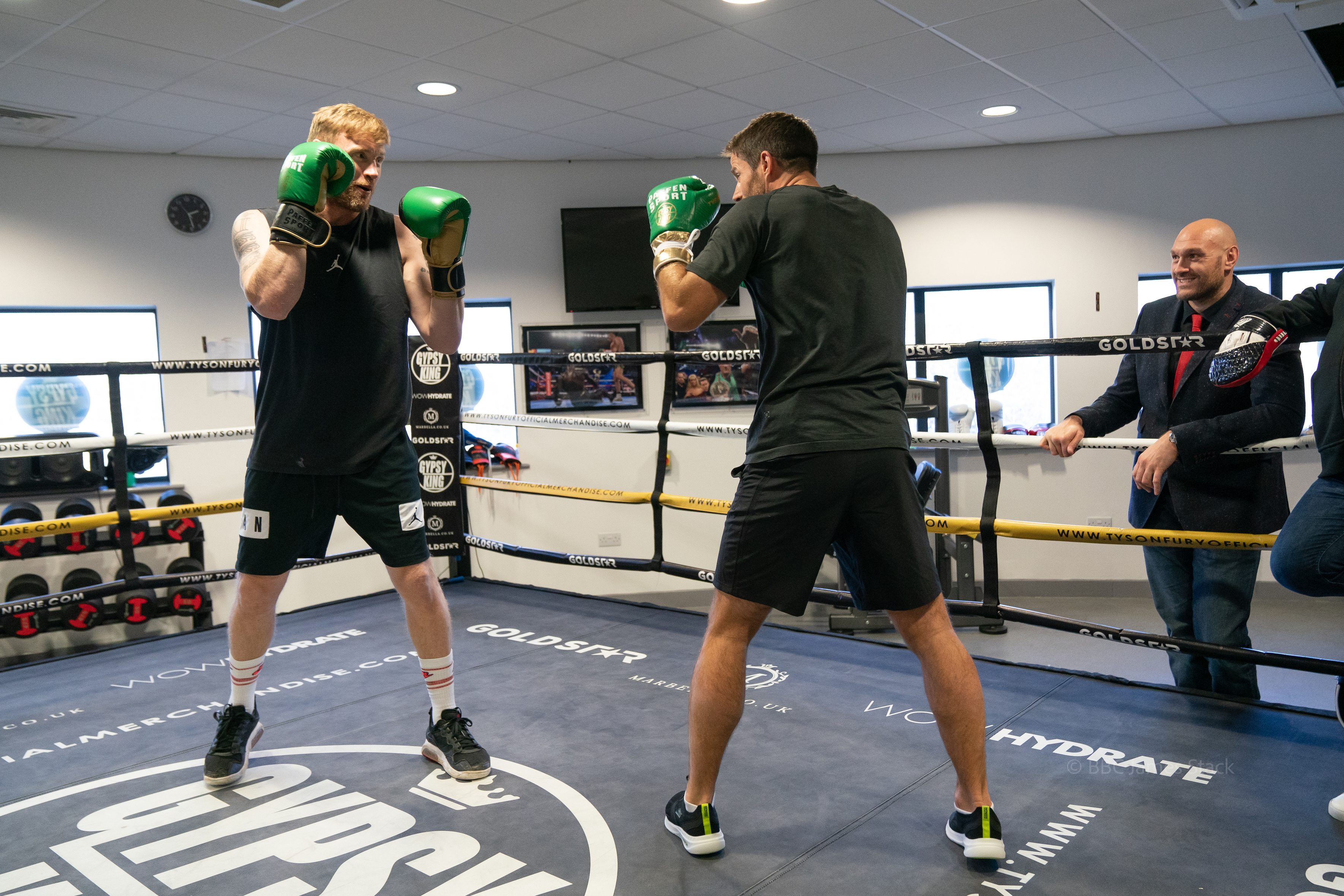 Who's king of the ring? Tyson Fury watches on as Jamie fights Freddie.