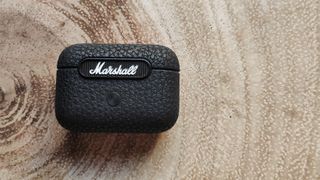 Marshall Motif ANC review: headphone charging case on a table