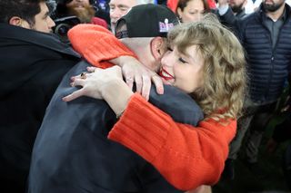 Travis Kelce #87 of the Kansas City Chiefs celebrates with Taylor Swift after a 17-10 victory against the Baltimore Ravens in the AFC Championship Game.