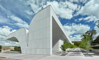 White exterior of building and sweeping roof design