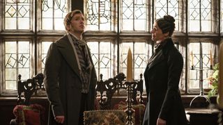 Mr Harper (Luke Newberry) in grey coat and waistcoat with Anne Lister (Suranne Jones) in a dark coat in Gentleman Jack.