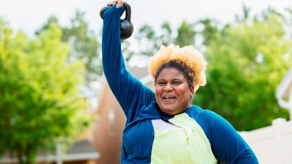 Woman lifting a kettlebell above her head
