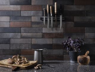 burnished polished tiles in various tonal grey shades in an industrial style kitchen