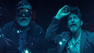 Sam and Wally standing in awe in blue light with strange orbs of light floating around them in The Boroughs