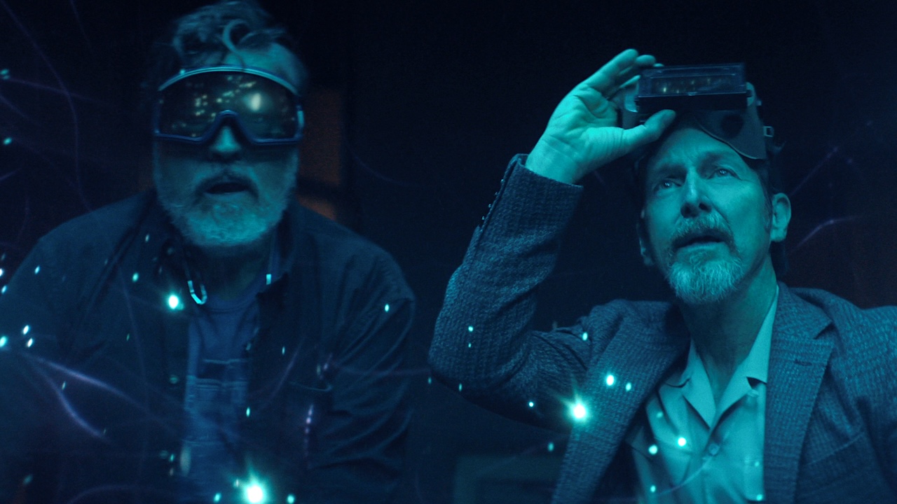 Sam and Wally standing in awe in blue light with strange orbs of light floating around them in The Boroughs