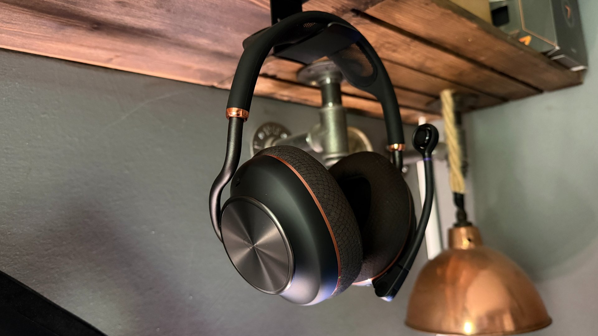 The Turtle Beach Stealth Pro 2 wireless gaming headset on a headset hangar underneath a wooden desk