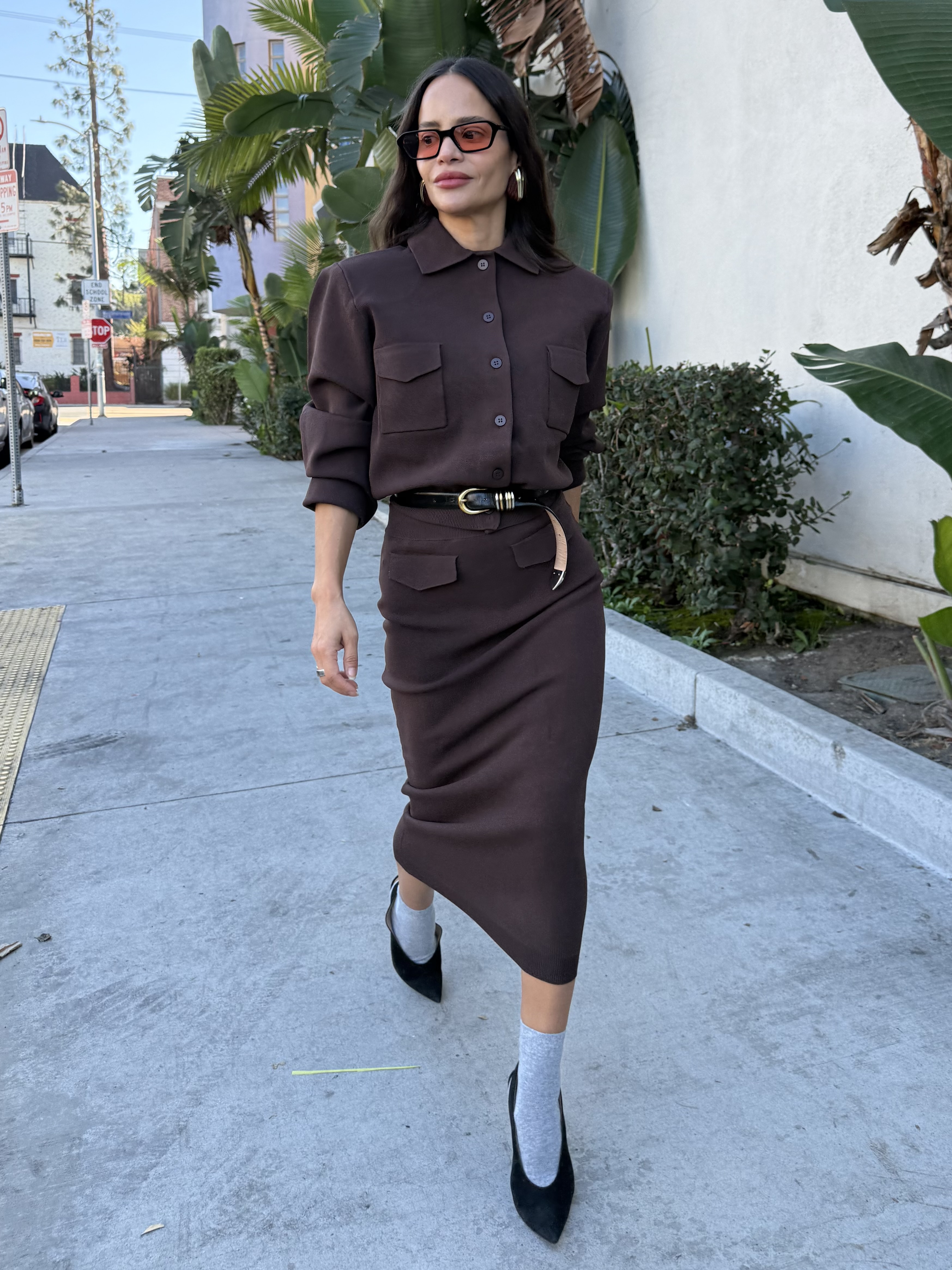 Sophie Lopez wearing a dress, a belt, socks, and heels