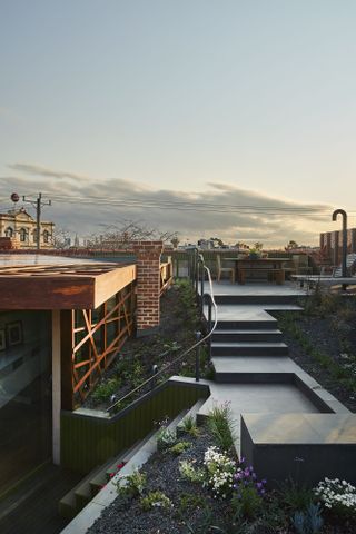 Stairs at left lead from the open plan kitchen/diner to the stepped roof terrace garden