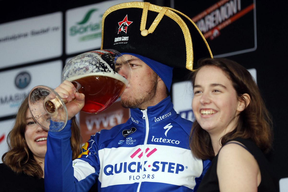 Remi Cavagna celebrates with some beer after winning Dwars door West-Vlaanderen