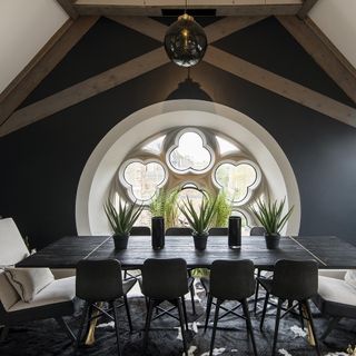 attic dining area with black table and chairs