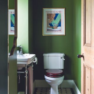 Greek cloakroom with white toilet and wooden door