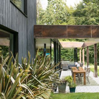 timber cladding with wooden table and potted plant