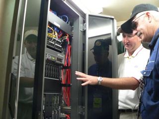 NASCAR's Steve Worling shows off the two 32 U HP ProLiant server racks to analyst Rob Enderle