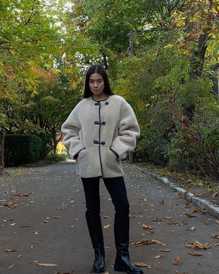 @sasha.mei wearing a Mango coat