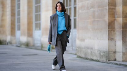 woman in blue oversized sweater and a gray suit