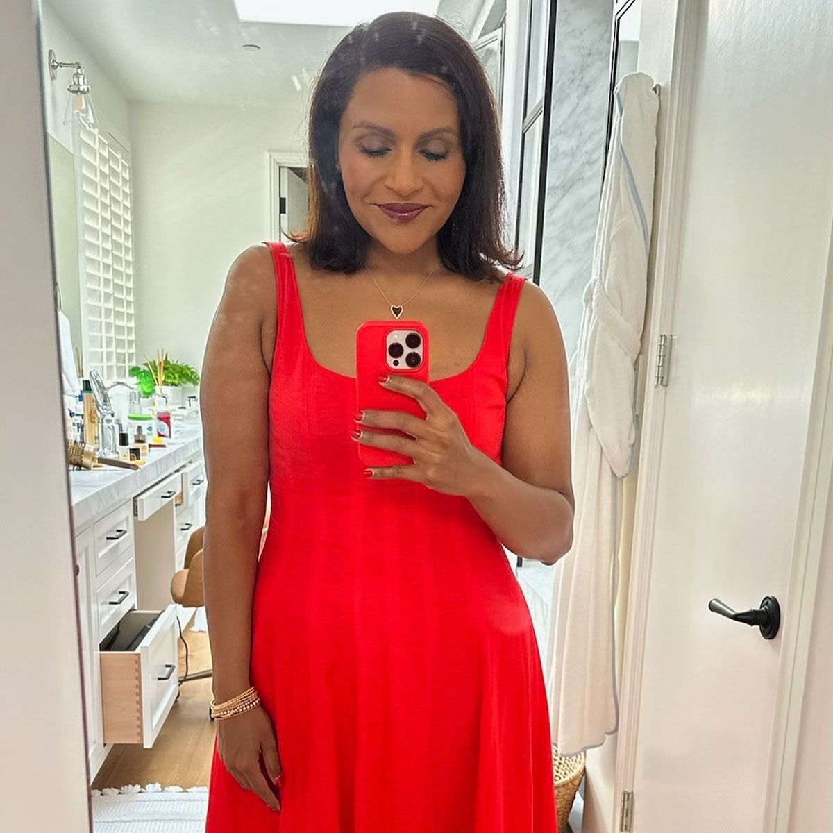 mindy kaling red dress 7 Red Midi Dresses to Wear When You Want to Stand Out