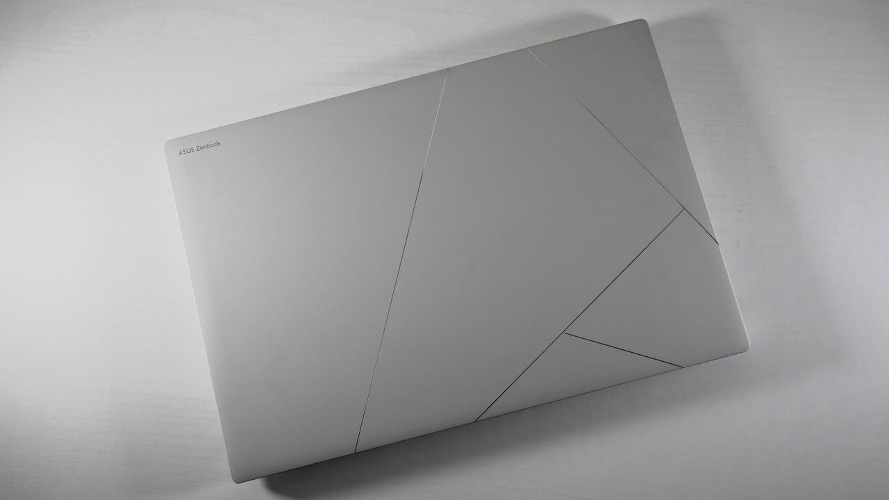 Asus Zenbook S16 UM5606 (Ryzen AI 9) closed on a white desktop showing the stylized Asus logo on the lid.