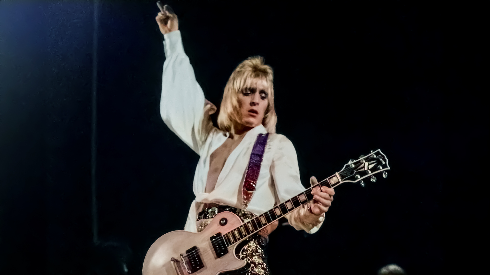 Mick Ronson performs with David Bowie's backup band the Spiders From Mars circa 1972.