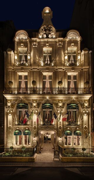Illuminated exterior of the Hotel Dillon, Paris, at night