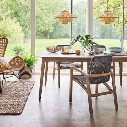 outdoor dining area with dining table and glass door