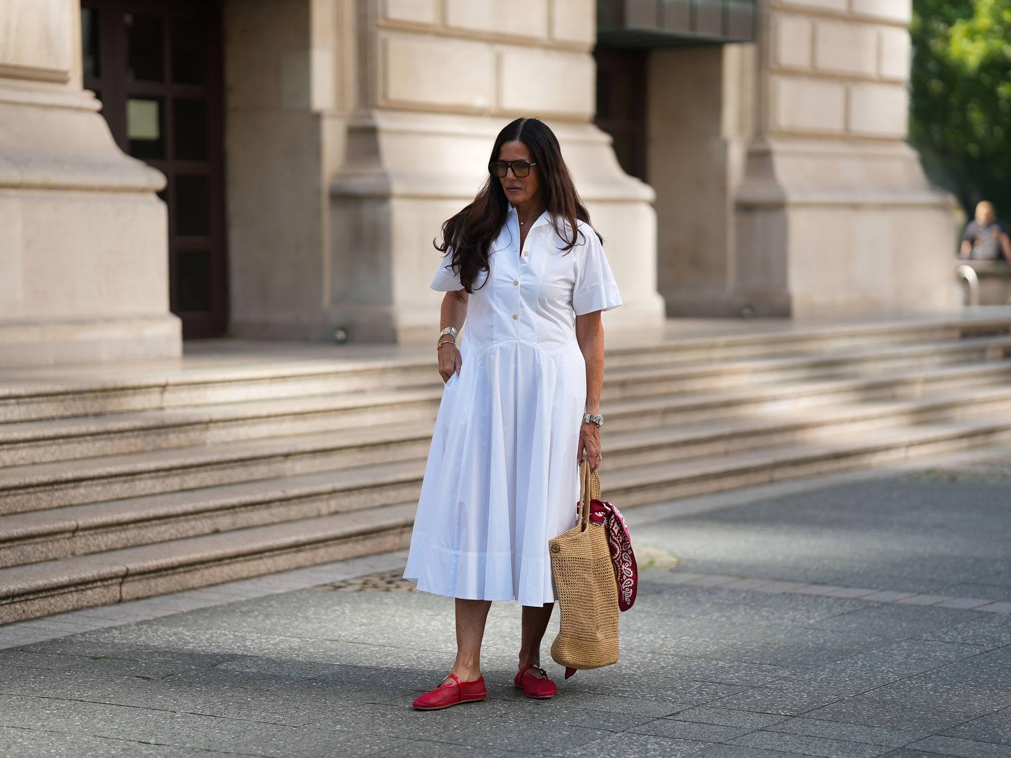 a woman wears a white shirtdress