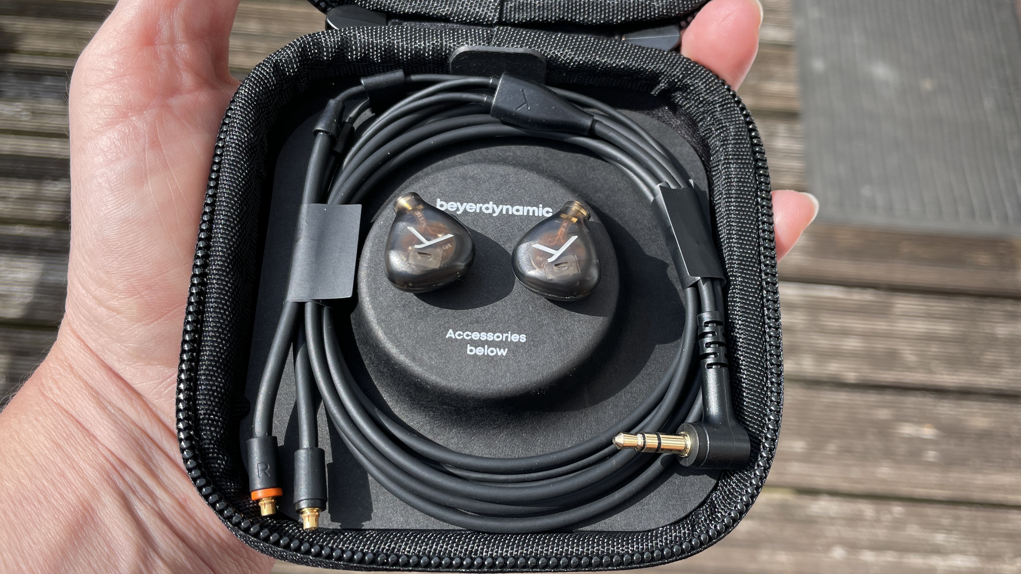 Beyerdynamic&#039;s DT 72 IE earbuds for vocals and guitar on brown background, showcasing the accessories