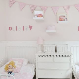girls room with bunting pink colour and toy
