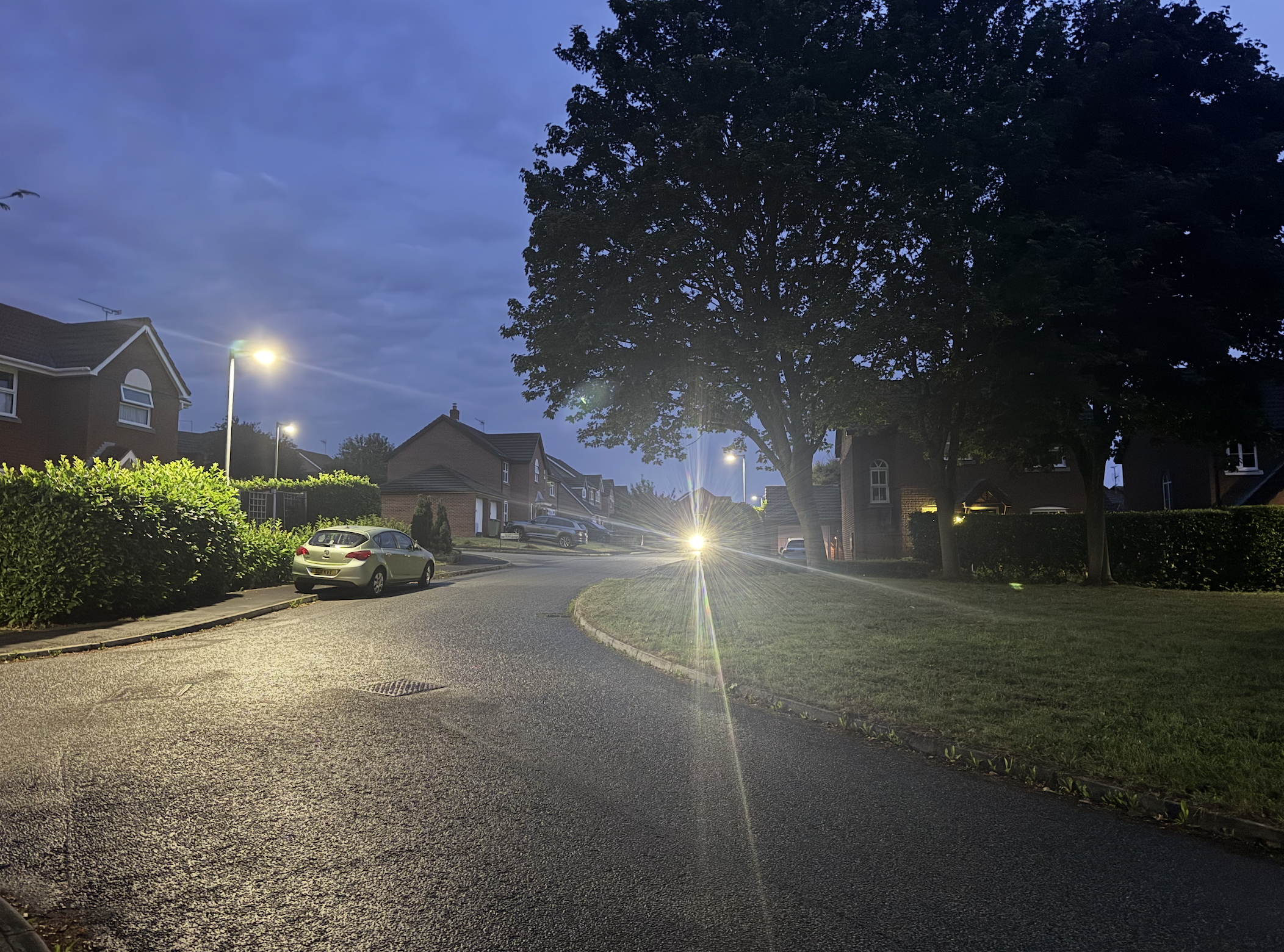 A simple street scene with the glowing orb of the Magicshine ALLTY in the distance.