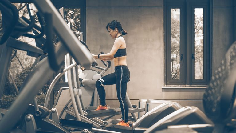 Do ellipticals build muscle? Woman using machine to workout
