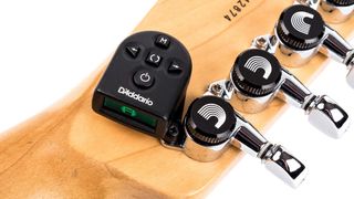 Best clip-on guitar tuners: Close-up of D'Addario NS Micro tuner attached to a guitar's headstock