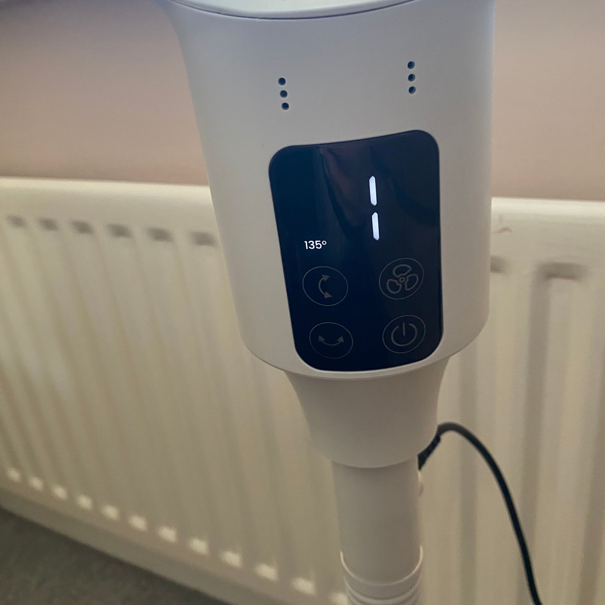 Control panel of the Pro Breeze Airflo 43'' Hybrid Pedestal Fan next to a radiator 