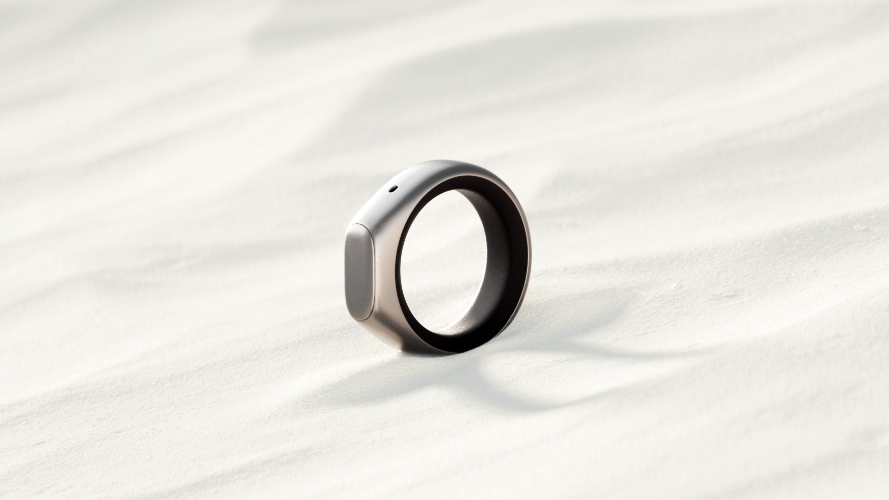 Stream Ring promo image showing the ring in a field of sand