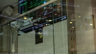 A close up photo of a glass panel with the words London Stock Exchange engraved