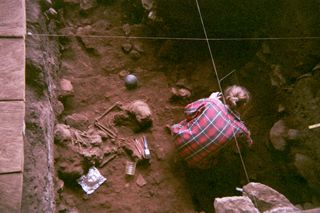 A researcher excavates the ancient bones at the Shum Laka rock shelter, which holds the remains of children who lived about 8,000 years ago.