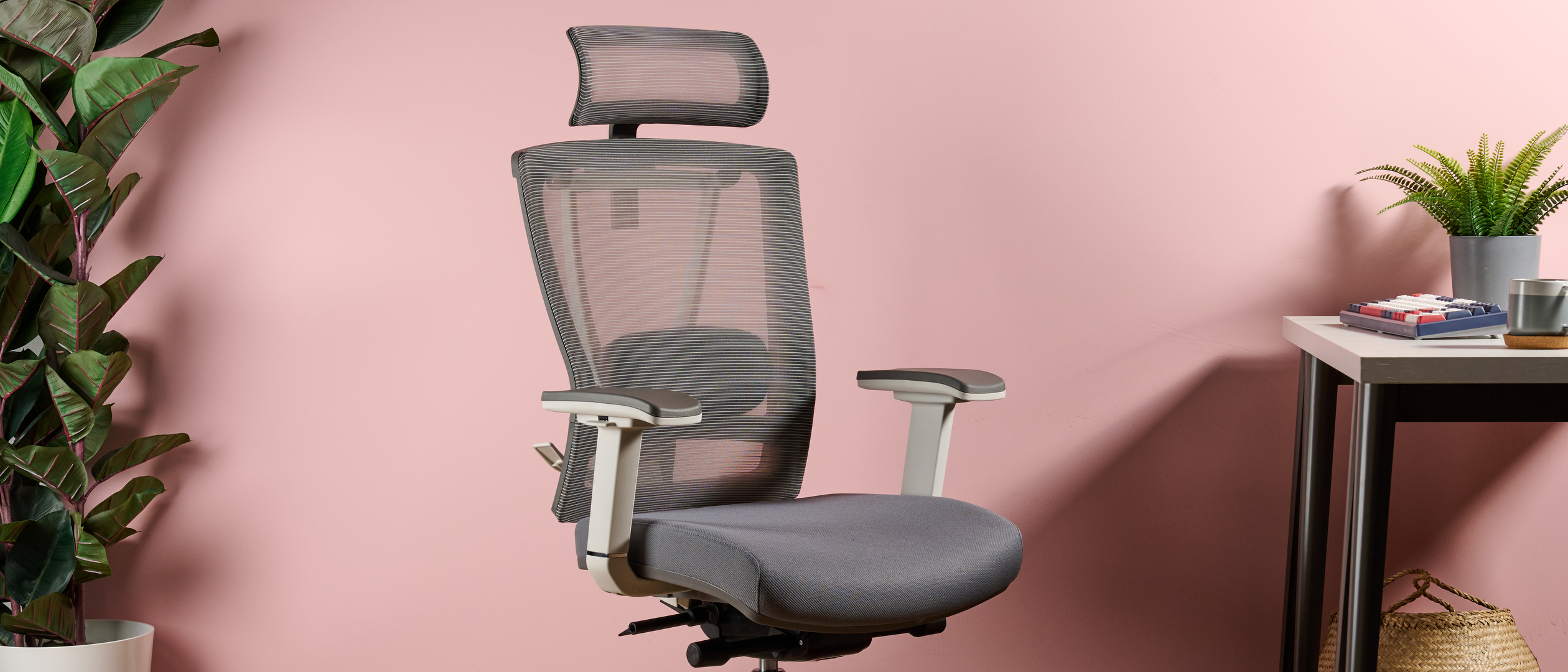 The FlexiSpot Ergonomic Office Chair BS14 is pictured against a pink background.