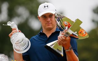 Jordan Spieth poses on the 18th green after winning both the Tour Championship by Coca-Cola and the FedEx Cup. Credit: Cox/Getty Images