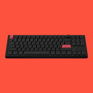 Keychron keyboard on a red background.