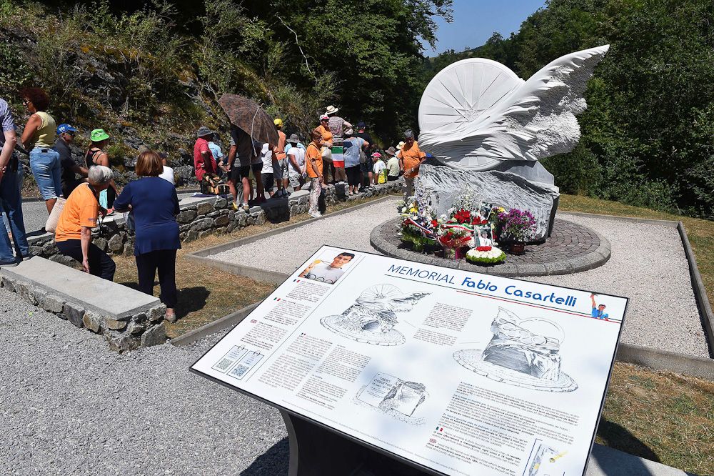 Specatators visit a memorial to Fabio Casartelli along Thursday's route.