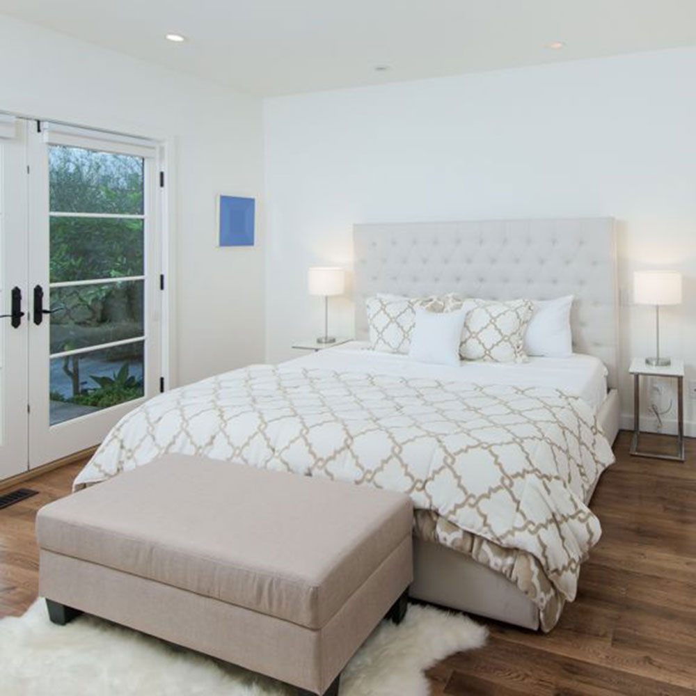 bedroom with white wall and bed