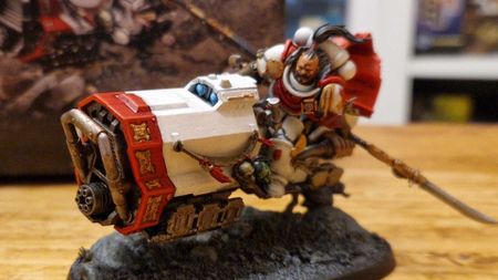 A white-armored Space Marine model on a jet bike