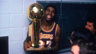 Magic Johnson holding the Walter A. Brown championship trophy