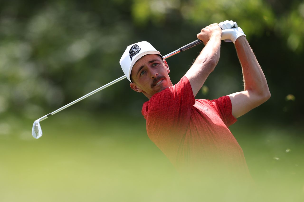 David Puig hits an iron from the fairway