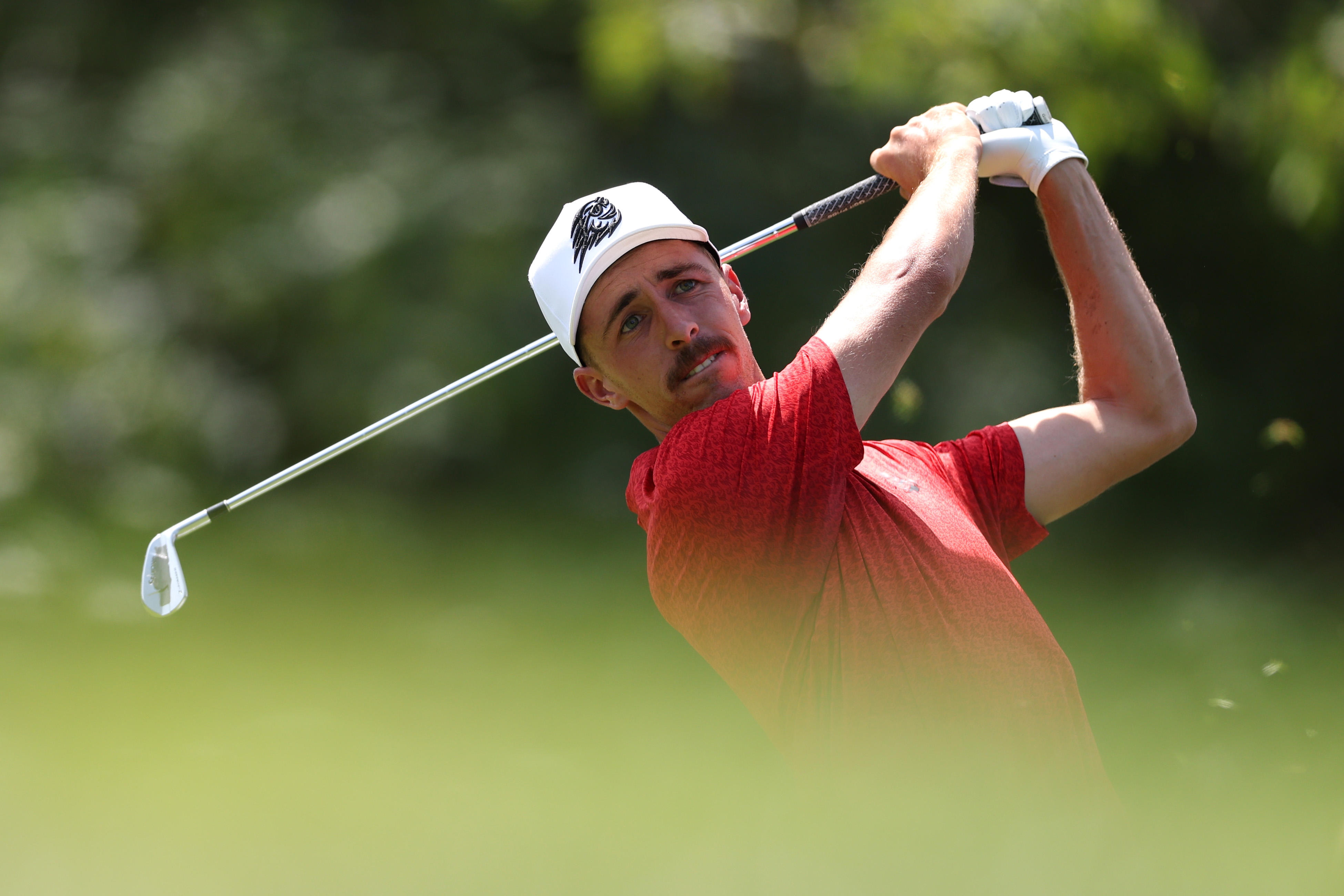 David Puig hits an iron from the fairway