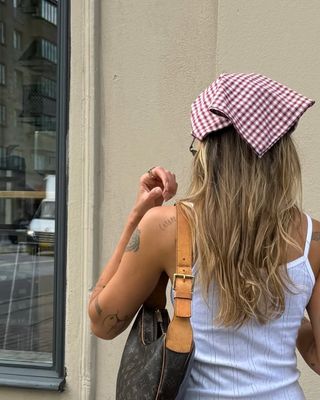 woman wearing headscarf and white tank