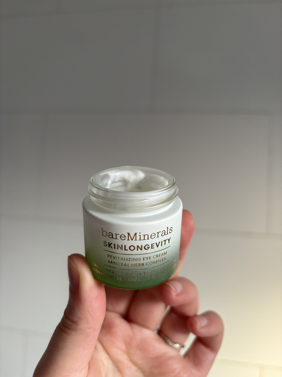 Mica Ricketts holding BareMinerals SkinLongevity Revitalizing Eye Cream