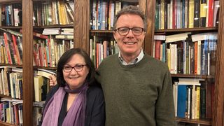 Professor Soledad Luque and Nicky Campbell stand together in front of book shelves in Long Lost Family Special: The Spanish Baby Scandal.